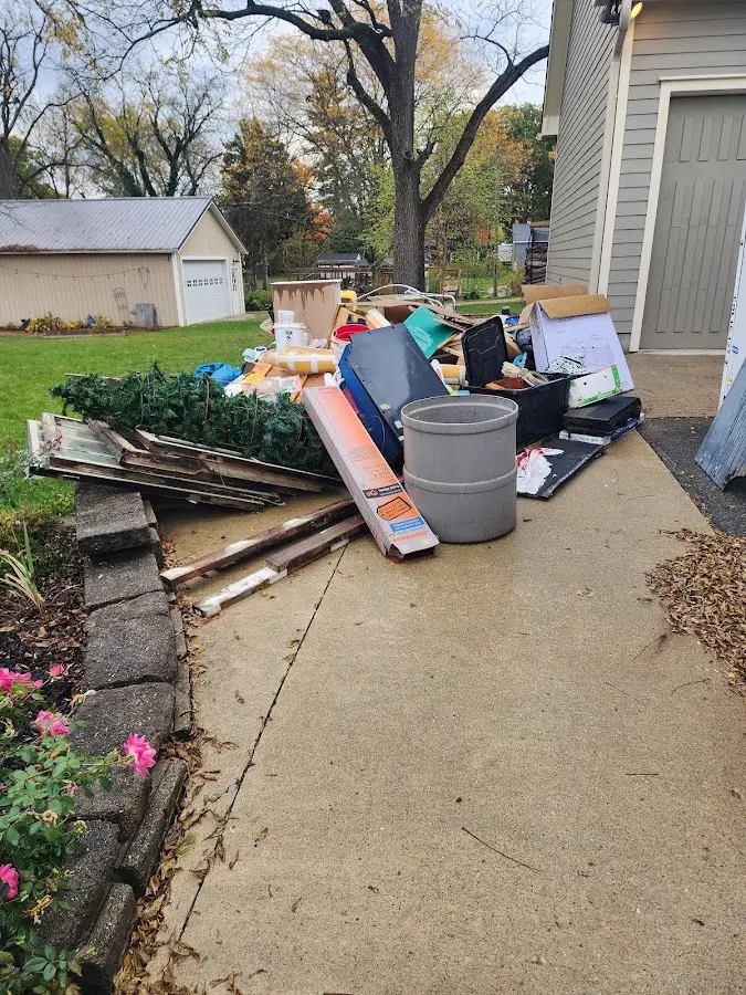 Dumpster being loaded with debris for Estate Cleanout Dumpster Rental in Harrington
